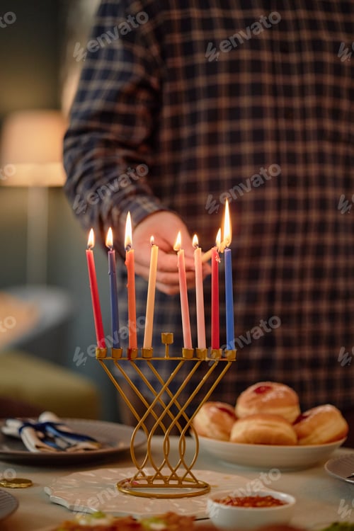 Preview: Man Lighting Menorah Candles Celebrating Hanukkah