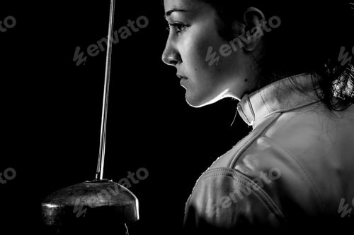 Preview: Portrait of woman wearing white fencing costume practicing with the sword.