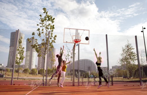 Preview: Happy active elderly women play basketball on urban court. Three mature female friends