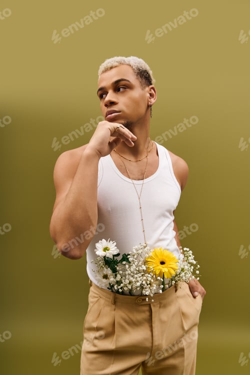 Preview: Young man showcases vibrant style with flowers in trendy studio setting