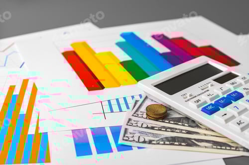 Preview: Business graphs paper and calculator on table