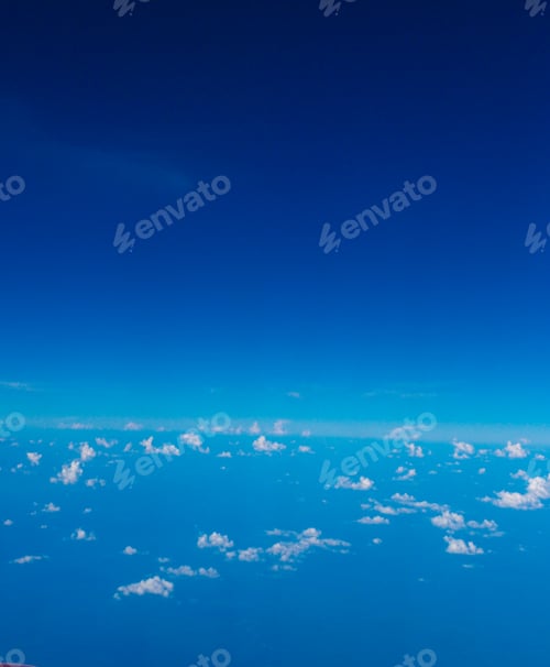 Preview: Blue sky with clouds and sun on airplane view