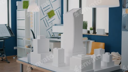 Preview: Concept of building model and construction design on table in empty workplace