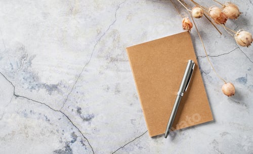 Preview: Home office workspace layout with a craft notebook, pen and dried bouquet on gray marble background.