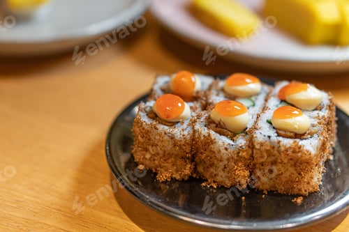 Preview: close up of sushi with chopsticks and soy