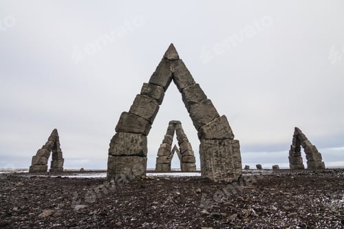 Preview: Arctic Henge surrounded by a field covered in the snow under a cloudy sky in Iceland