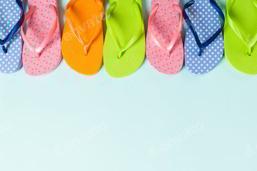 Preview: a lot of flip flop colored sandals, summer vacation on colored background, copy space top view