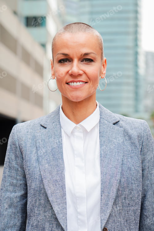 Preview: Vertical individual portrait of a businesswoman smiling and looking at camera with proud expression