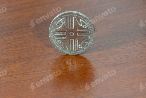 Preview: Colombian coin 200 pesos of 1997, currency over wood texture.