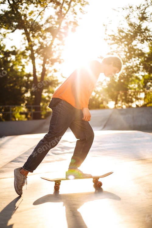 Preview: Young skater skateboarding while spending time in modern skatepa