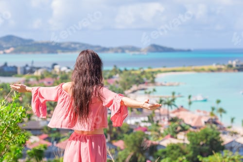 Preview: Young tourist woman with view of bay at tropical island in the Caribbean Sea