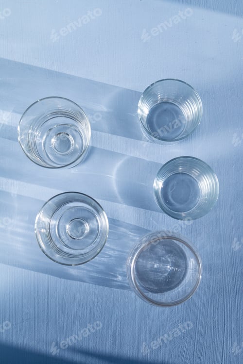 Preview: Drinking glass flat lay view, abstract shadows