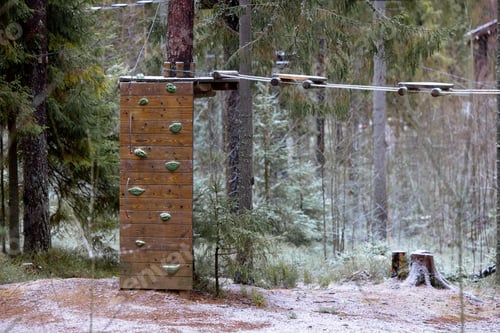 Preview: wall with climbing holds in winter forest