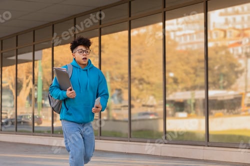 Preview: Rushing student holding a tablet and bag
