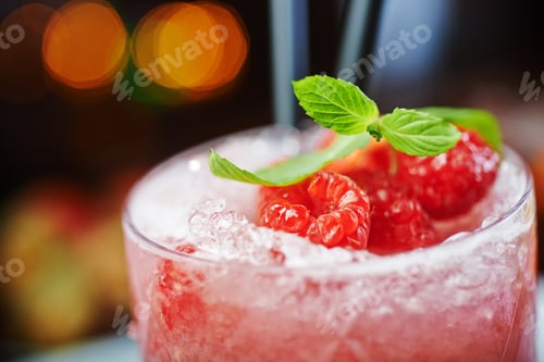Preview: bright beautiful bright glass of alcoholic cocktail or lemonade on a table in a bar. soft focus.