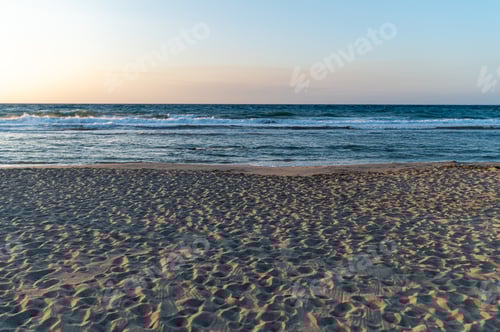 Preview: Sunset beach view in Crete, Greece with gentle waves and sandy shoreline
