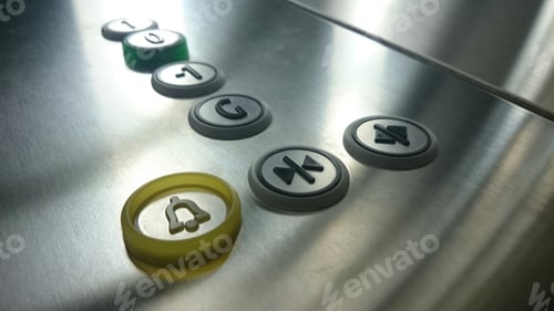 Preview: Tech elegant and modern elevator buttons on silver brushed metal bottom in soft sunny light