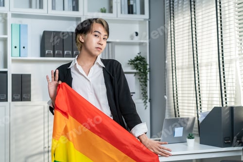 Preview: Portrait of Asian businessman gay working in office, holding LGBT flag.