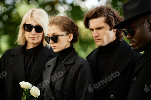 Preview: People dressed in black at outdoor funeral