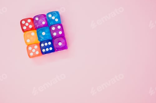 Preview: Cube made of colorful dice isolated on a pink background