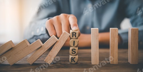 Preview: close-up hand The hand of a businessman who is stopping or preventing a falling block