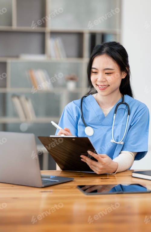 Preview: Female doctor sitting at desk and writing a prescription for her patient