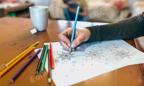 Preview: Detail of woman's hand coloring mandalas