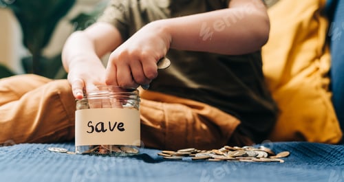 Preview: Child Saving Coins in Jar at Home