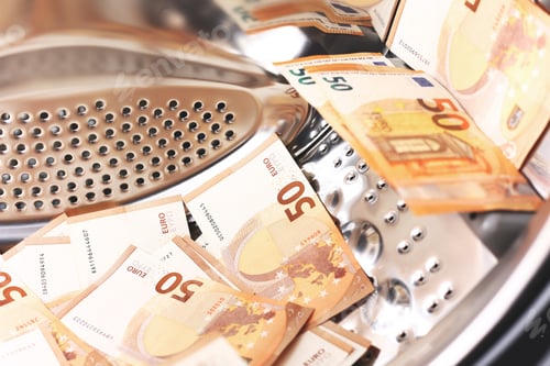 Preview: Money laundering symbol, 50 euro banknotes inside washing machine. Tax evasion. Illegal financ