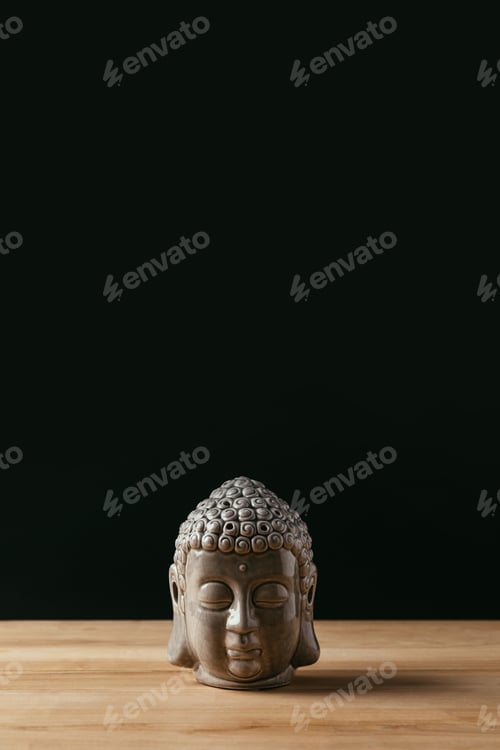 Preview: Sculpture of buddha head on wooden table