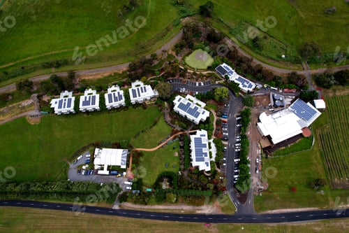 Preview: Drone photo looking down at winery, green fielded solar panel roofs