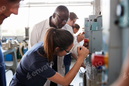 Preview: Engineer training female apprentice using a drill press