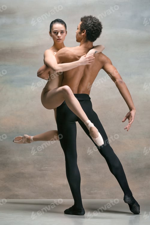 Preview: Couple of ballet dancers posing over gray background