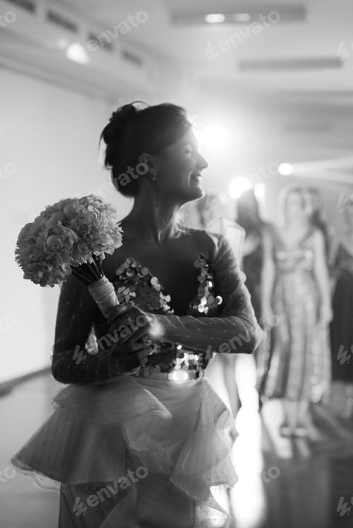 Preview: bride in a white dress throws a wedding bouquet