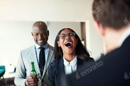 Preview: Young African American businesswoman laughing over office drinks with colleagues