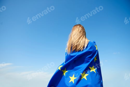 Preview: Rear view of young woman covered with European Union Flag