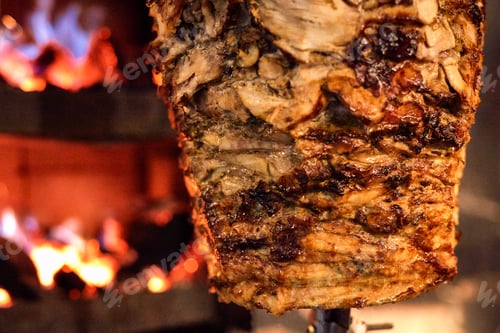 Preview: Close up shot of stacked meat roasting to be used in preparation of traditional Greek dish gyros or
