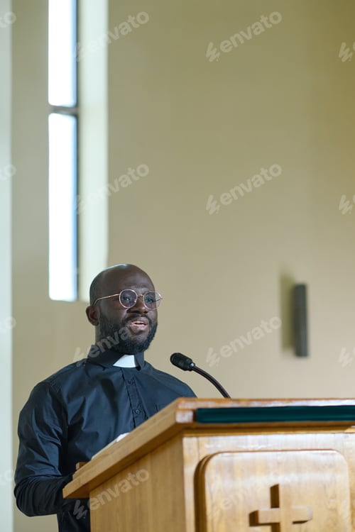 Preview: Young confident African American man in black shirt speaking in microphone