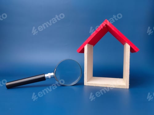 Preview: Toy house and magnifying glass on a blue background