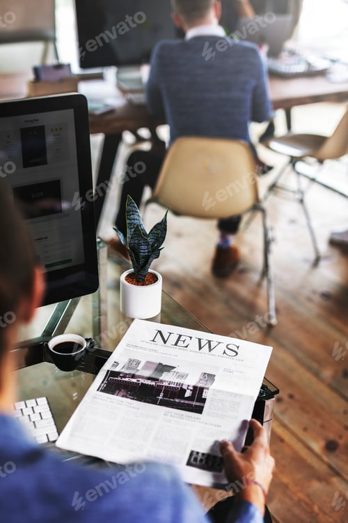 Preview: Businessman reading a newspaper