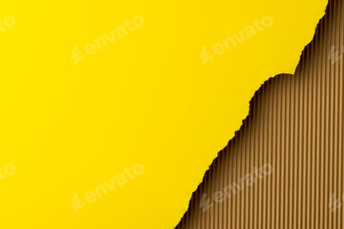 Preview: Ripped up pieces of yellow paper with copy space on cardboard background