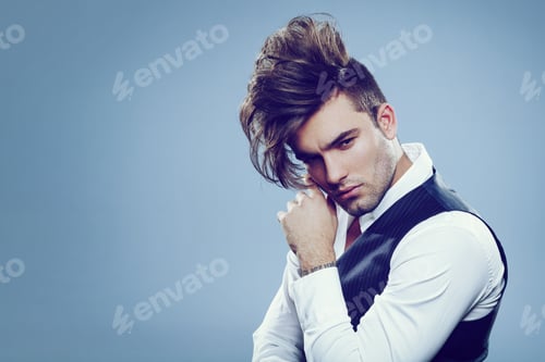 Preview: Handsome man with modern hairstyle in studio