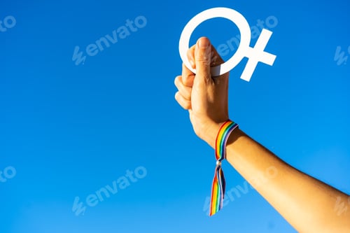 Preview: Blue sky background with a hand of a woman with female symbol in favor of feminism