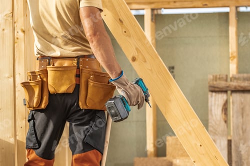 Preview: Construction Worker Using a Cordless Drill on a Building Site During Daylight Hours