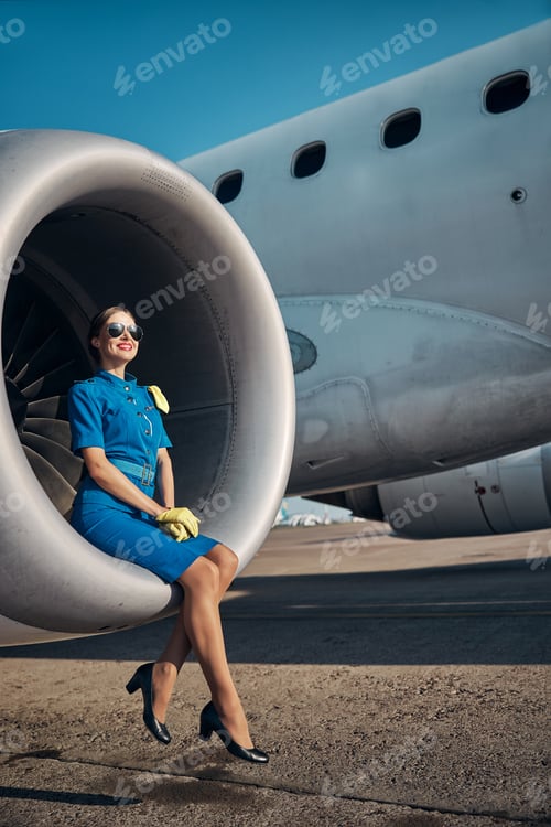 Preview: Happy young stewardes relaxing on jet turbine