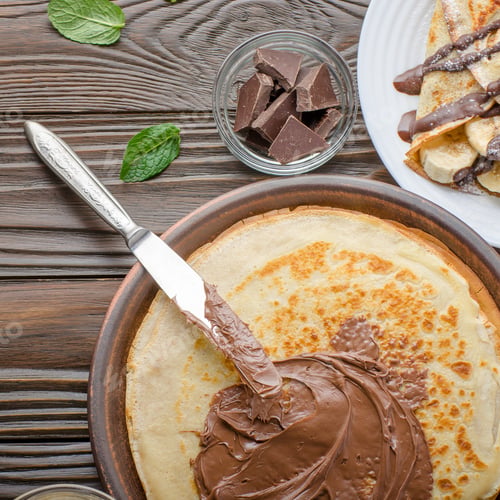 Preview: Flat lay French crepes with chocolate peanut butter sauce and ba