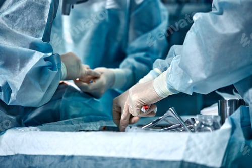 Preview: Hands of a team of surgeons close-up in the operating room during the operation, sterile instruments