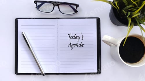 Preview: "Today's Agenda" Notebook, Coffee, Alarm Clock, and Eyeglasses on White Background