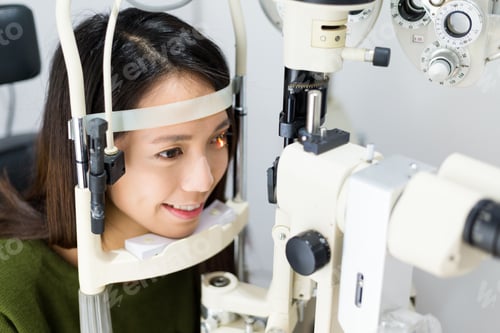 Preview: Woman taking the vision exam in eye clinic