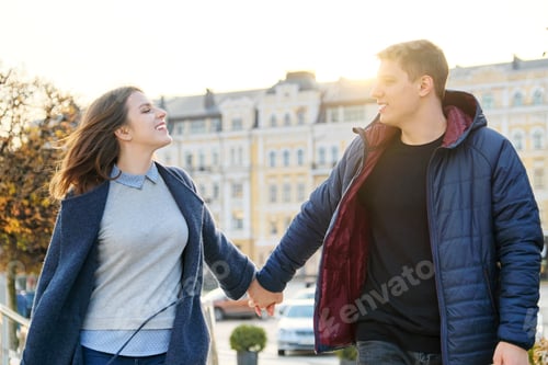 Preview: Young couple happy man and woman holding hands
